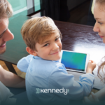 A kid with his parents using a mobile tablet