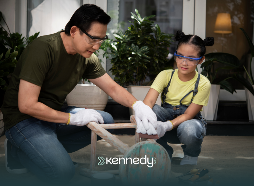A kid with autism helping his dad paint a stool chair outdoors