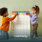 Two kids looking at a big calendar