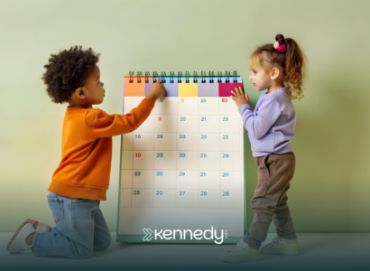 Two kids looking at a big calendar
