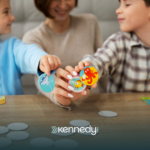 Two kids and an ABA therapist doing cooperative play in ABA therapy
