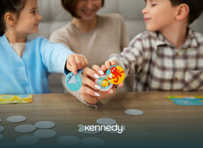 Two kids and an ABA therapist doing cooperative play in ABA therapy