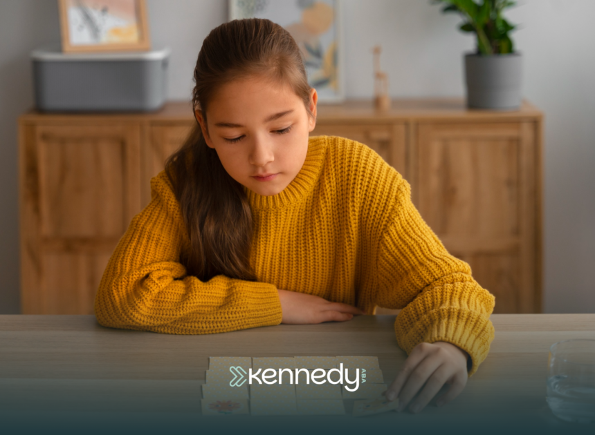 An autistic teenager sitting a table