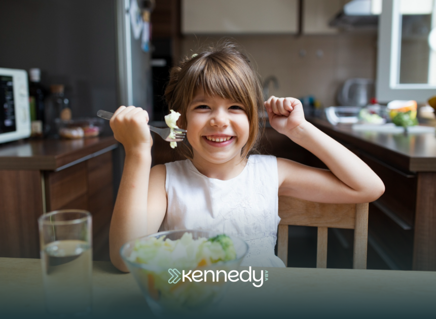 A kid happily eating vegetables on a table
