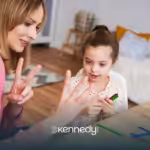 A BCBA helping a child communicate during ABA therapy