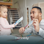 An ABA therapist helping a girl using letter flash cards during ABA therapy