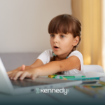 A kid with autism playing Minecraft on a laptop computer