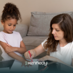 A BCBA and a girl using crayons during ABA therapy