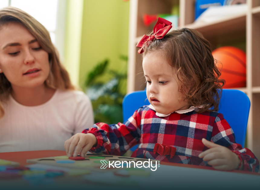 A kid and an ABA therapist during school-based ABA therapy