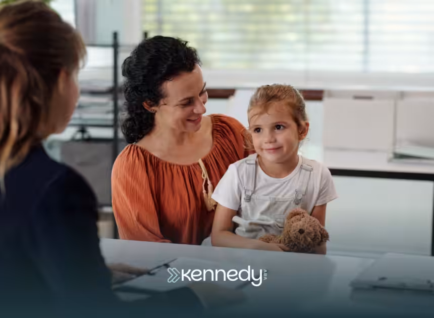 A mother holding her child talking to an insurance agent