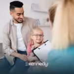 A father holding her child talking to a Medicaid agent