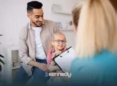 A father holding her child talking to a Medicaid agent