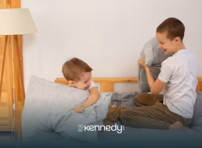 Two brothers playing pillow fight