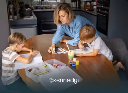 A mom guiding his two kids while doing art activities on a table