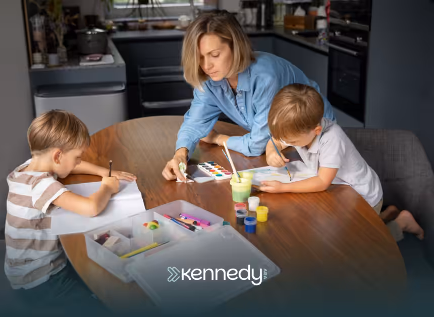 A mom guiding his two kids while doing art activities on a table
